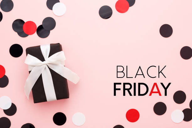Black friday card with gift box and confetti on pink background.