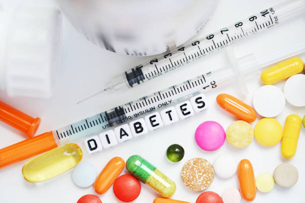 istock Type 2 diabetes diagnosis from plastic beads with many colourful pills and syringe on white background 1047557342