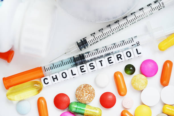 istock Health problems concept with cholesterol word from white plastic beads with colorful pharmaceutical drugs on white background 1047557496
