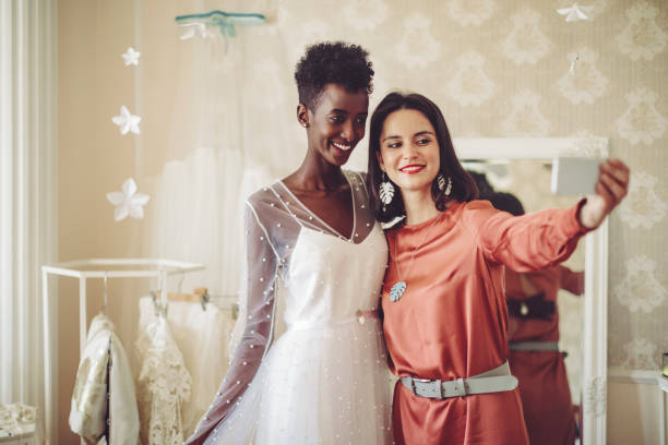 istock Fashion designer is taking a selfie with her happy client 1047558686