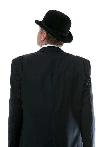 Businessman looking up Businessman in a bowler hat looking up to the future. Rear view. bowler hat stock pictures, royalty-free photos & images