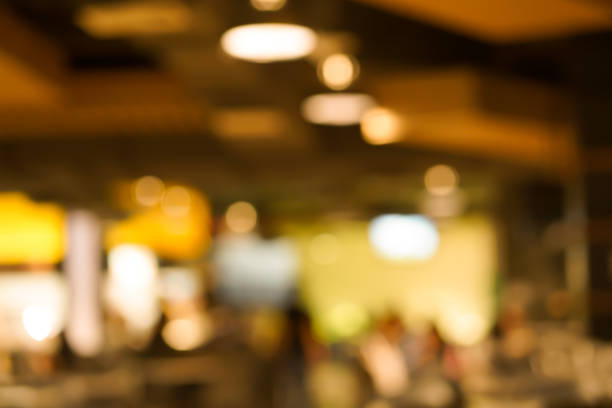 istock abstract blur beautiful interior coffee cafe with neon and lamp light background with vintage color filter tone for design 1047561934