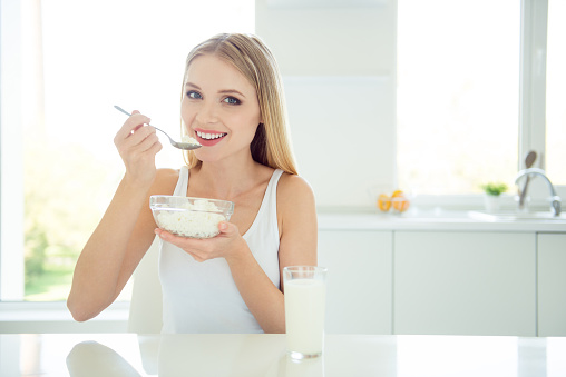 Yummy bio delicious aromatic useful natural tasty food concept. Close up photo portrait of beautiful pretty cute lovely charming attractive lady eating cheese sitting at table light loft modern room