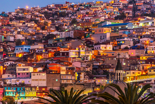 Casas de colores iluminados por la noche en un cerro de Valparaíso, Chile photo