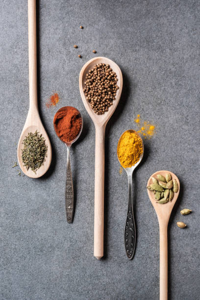 istock top view of different dried aromatic spices in spoons on grey  background 1047565092