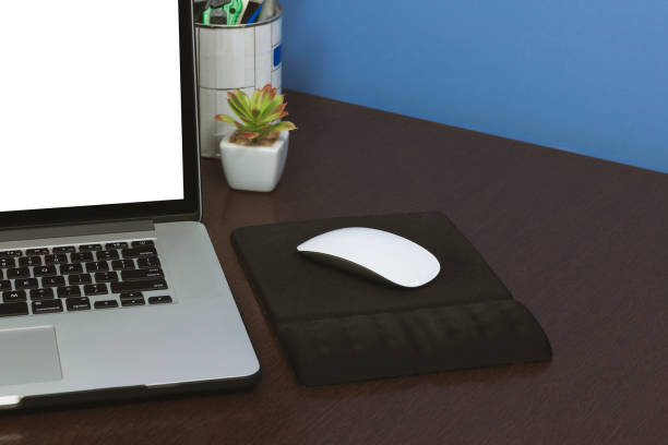 istock Desk Laptop blank text space screen in office on wood table. Laptop mock-up conceptual workspace image. 1047565452