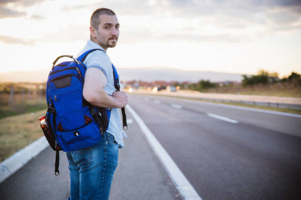Man at highway looking for transport.