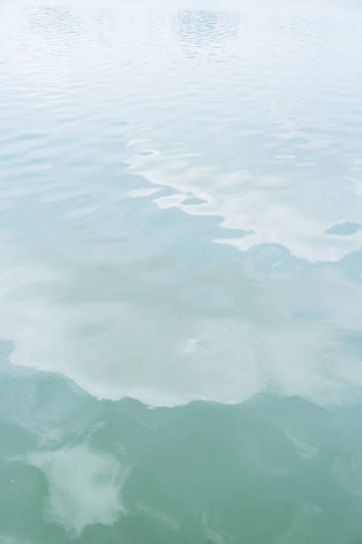 istock Lake with cloud reflected in the water 1047569608