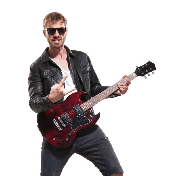 istock excited rockstar making rock on sign during concert 1047574398