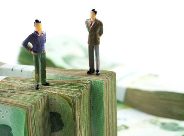 istock Miniature businessman on banknotes 1047574666