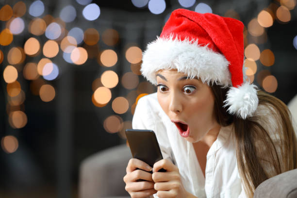 istock Amazed woman reading phone content in christmas 1047575210