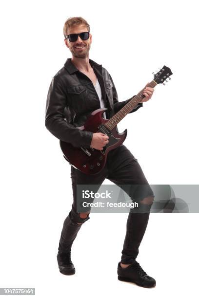 Young Rock Star Performing On Guitar And Smiling Stock Photo - Download Image Now - Cut Out, Men, Punk - Person