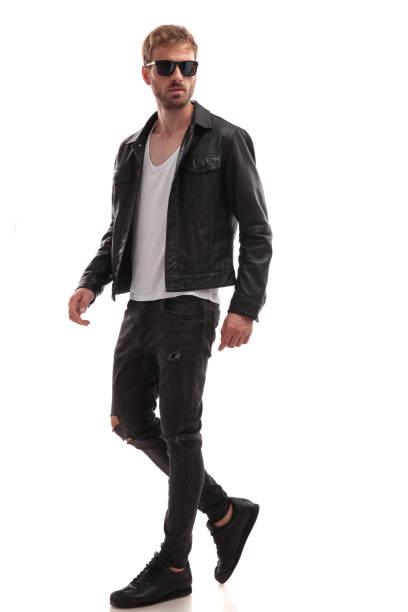 istock side view of cool young man with sunglasses walking 1047577524