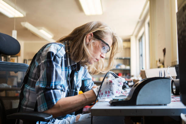 istock Woman soldering 1047581638