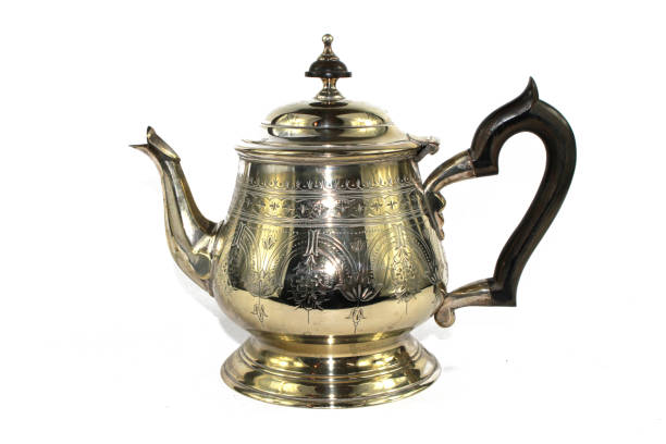 istock Quirky Vintage Antique Silver Kettle Teapot on White Background 1047581802