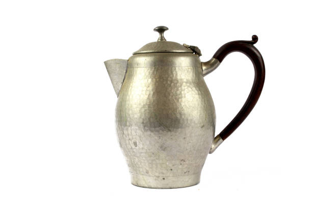 istock Quirky Vintage Antique Silver Kettle Teapot on White Background 1047585634