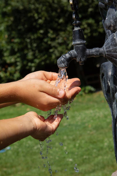 istock Pure water flowing into child's hands 1047589138