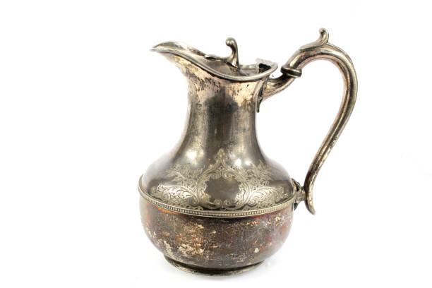 istock Quirky Vintage Antique Silver Kettle Teapot on White Background 1047589790