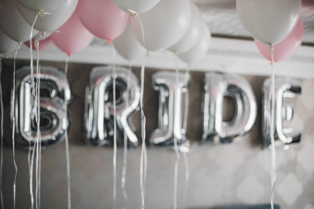 istock Bride letter balloons in hotel room 1047590110