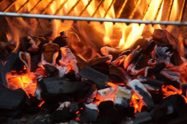 Flames, fires and coal in a barbecue. No character, face view, outside.