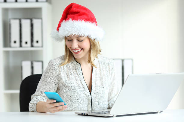 istock Employee checking phone at office in christmas 1047604444