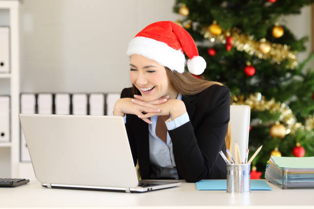 istock Happy employee reading on line at office in christmas 1047609336