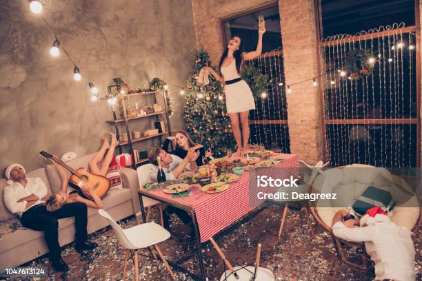 Top Above High Angle View Of Beautiful Attractive Stylish Classy Elegant Cheerful Funky People Girl Dancing On Dinner Table With Martini Guys Sleeping House Chillout Stock Photo - Download Image Now