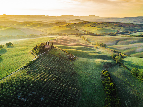Tuscany's valley in Val d'Orcia at sunrise from aerial point of view