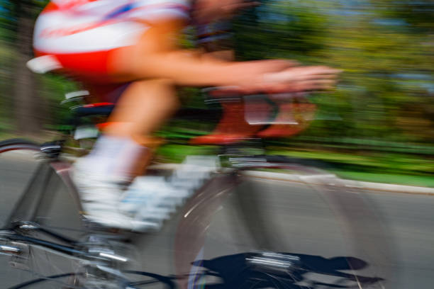 istock Racing bicycle in blurred motion speeding down the road. 1047617542