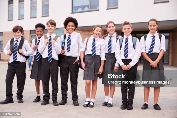 Portrait Of High School Student Group Wearing Uniform Standing Outside School Buildings Stock Photo - Download Image Now