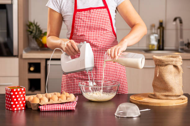 istock Woman pouring milk into a pancake dough 1047620760