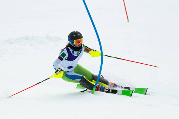 istock Young Women at Slalom Skiing Passing the Blue Gate 1047620900