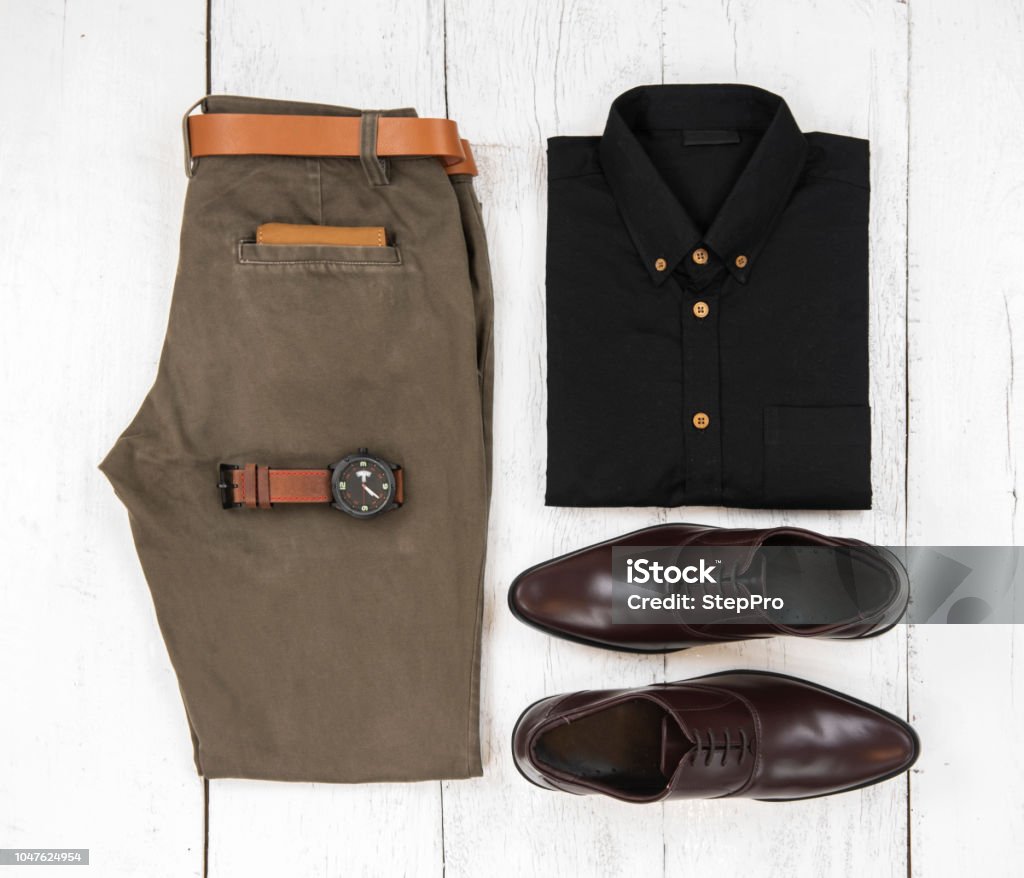 respektfuld lammelse Ekspert Mens Casual Outfits For Man Clothing With Brown Shoes Watch Belt Trousers  Black Shirt And Wallet Isolated On White Wooden Background Top View Stock  Photo - Download Image Now - iStock