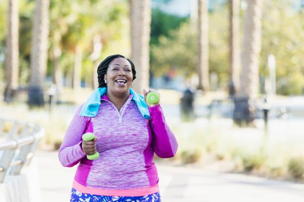 istock African-American woman exercising with hand weights 1047627620