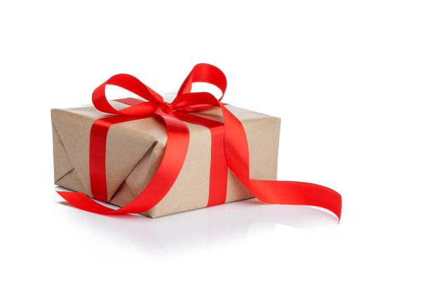 istock Brown gift box with red ribbon isolated on white background 1047628372