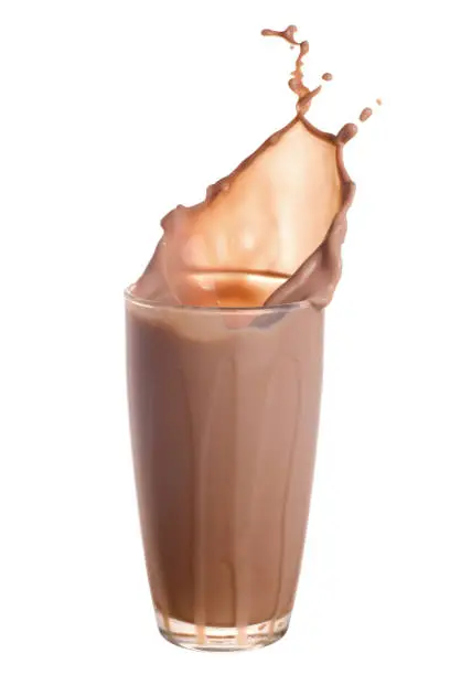 Chocolate milk splash out of glass isolated on white background.