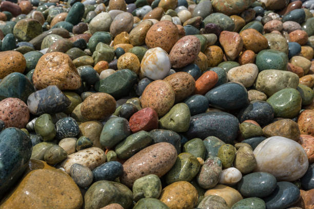 istock Wet, colorful, pebbles on Mediterranean beach. Texture, background concept. Close up. 1047631352