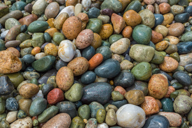 istock Wet, colorful, pebbles on Mediterranean beach. Texture, background concept. Close up. 1047631362
