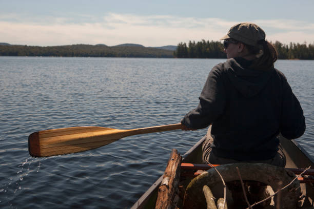 istock Woman paddling a canoe 1047631604