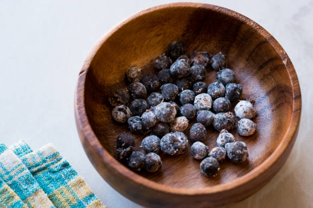 istock Black Raw Tapioca Pearls in Wooden Bowl. 1047634784