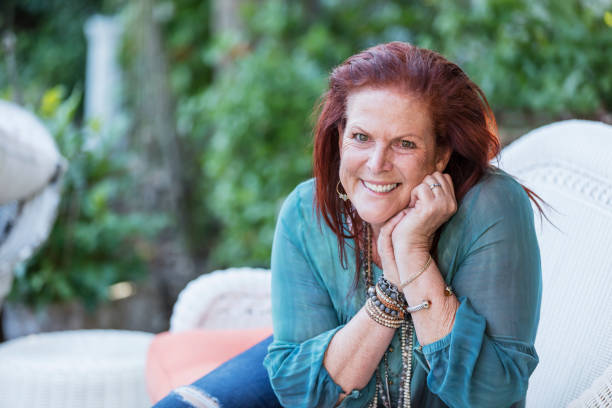 istock Mature woman sitting on patio sofa 1047635098