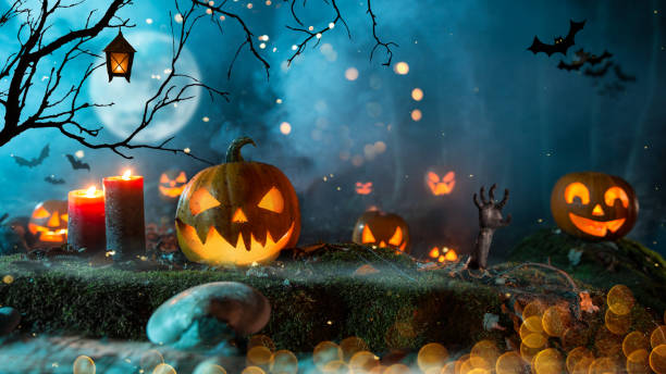 istock Halloween pumpkins on dark spooky forest. 1047635304