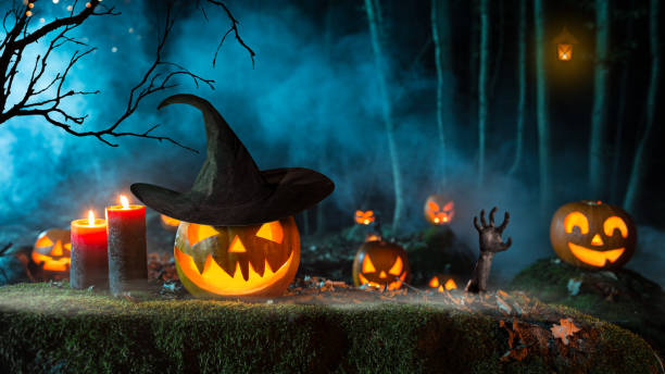 istock Halloween pumpkins on dark spooky forest. 1047635502