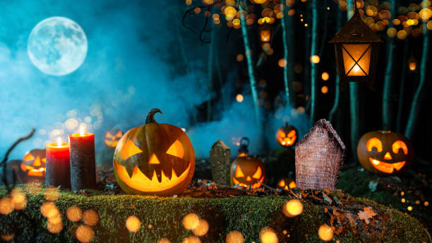 istock Halloween pumpkins on dark spooky forest. 1047635758
