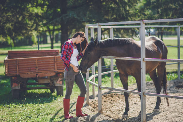 istock young woman and horse 1047636418