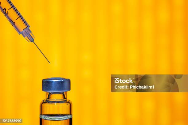 A Syringe With The Needle Point To The Vaccine Vial On The Colorful Abstract Background Stock Photo - Download Image Now