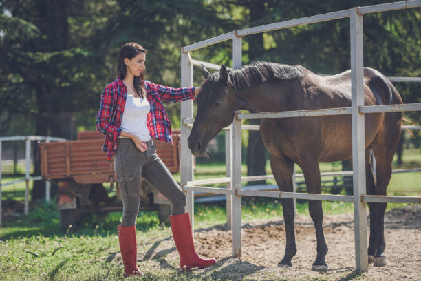 istock young woman and horse 1047639108