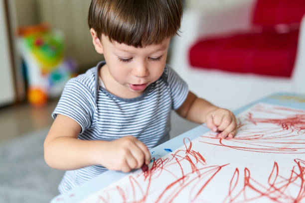 istock Cute child is drawing somethings 1047639116