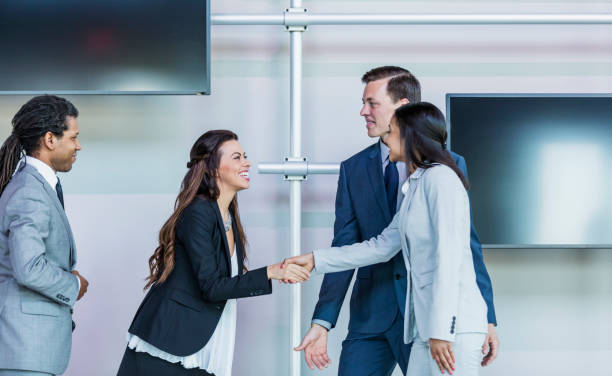 istock Multi-ethnic business people, women shaking hands 1047639142