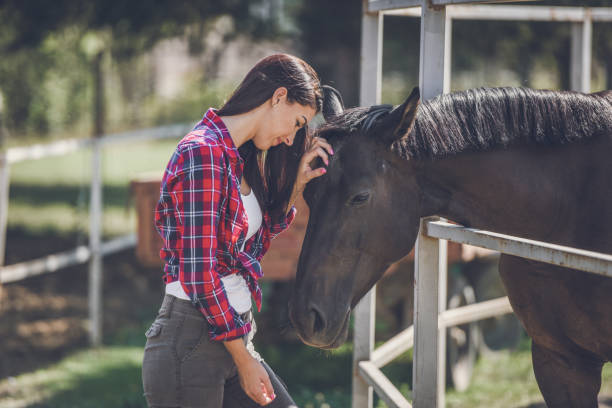 istock young woman and horse 1047639874
